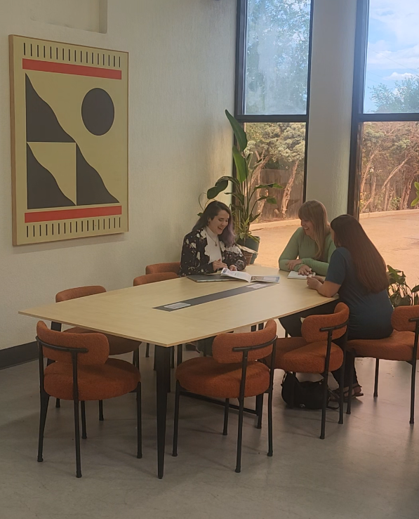 women sitting around a conference table discussing business