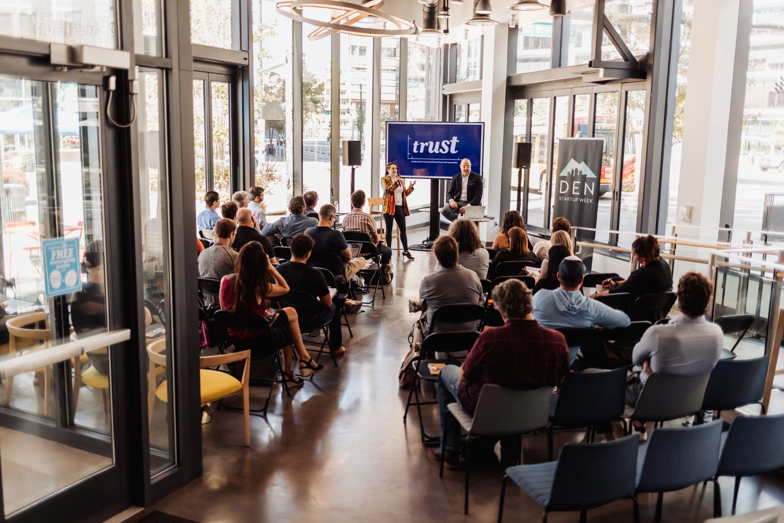 business woman presenting in front of a crowd at denver startup week